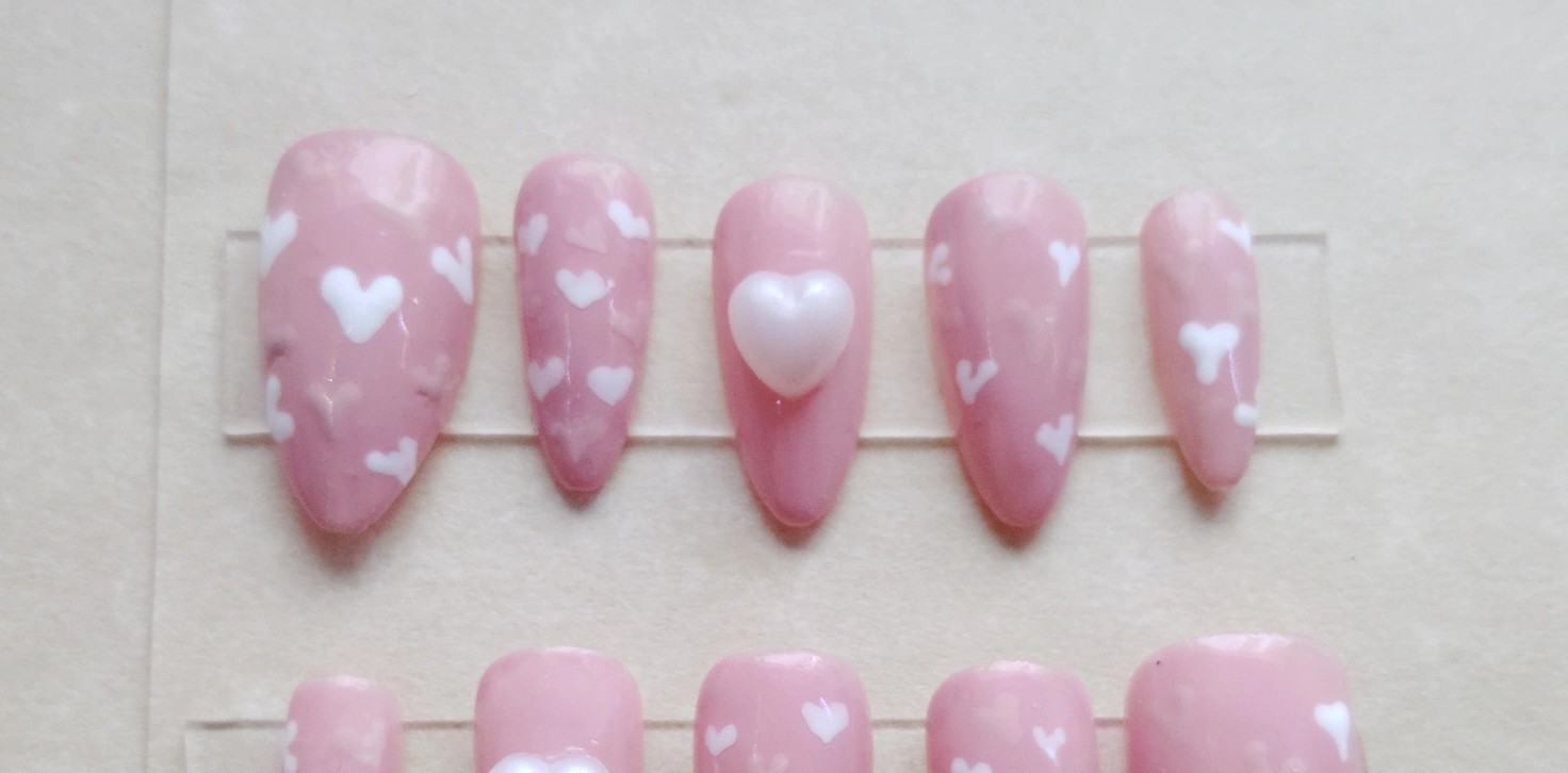 Pink press-on nails with hand-painted hearts